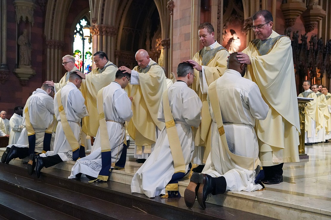 Priests lay their hands upon the candidates for the Ordination of Priests on Saturday, May 18, 2024, at The Cathedral of the Immaculate Conception in Albany, N.Y.  Cindy Schultz for The Evangelist