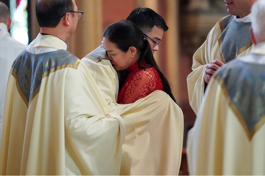Newly ordained priest Joseph Tuan Van Pham, center, embraces his mother (tracking down name) once he’s vested with stole and chasuble during the Ordination of Priests on Saturday, May 18, 2024, at The Cathedral of the Immaculate Conception in Albany, N.Y.  Cindy Schultz for The Evangelist
