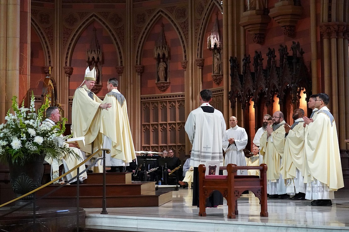 Bishop Edward B. Scharfenberger, left, embraces newly ordained priest Thomas Fallati during the Ordination of Priests on Saturday, May 18, 2024, at The Cathedral of the Immaculate Conception in Albany, N.Y.  Cindy Schultz for The Evangelist
