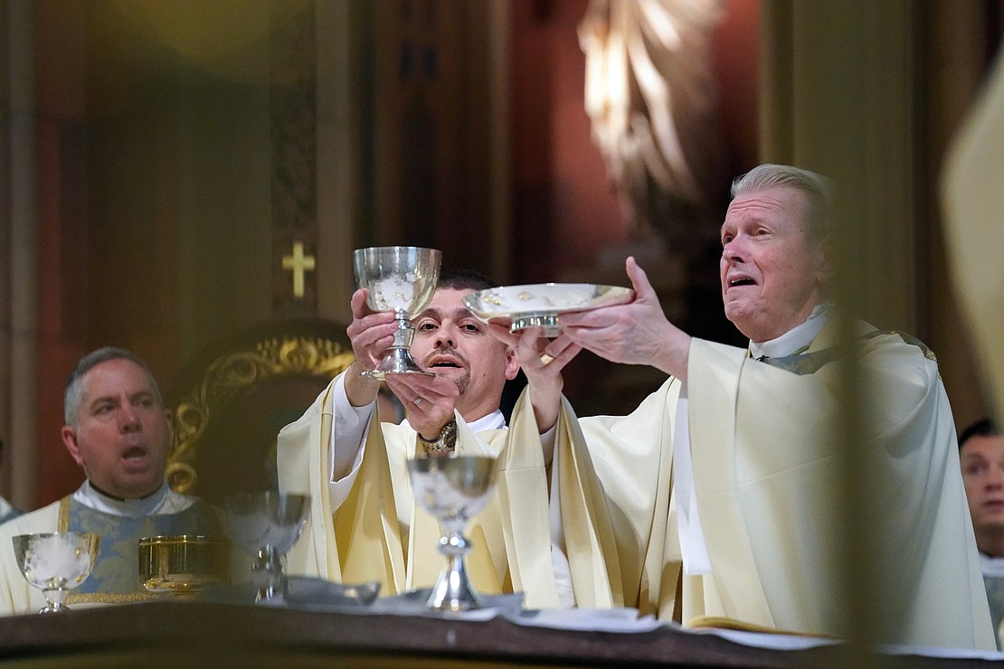 Deacon Eric Ramirez, second from left, assists Bishop Edward B. Scharfenberger with the Liturgy of the Eucharist during the combined Ordination of Deacons and Priests on Saturday, May 18, 2024, at The Cathedral of the Immaculate Conception in Albany, N.Y.  Cindy Schultz for The Evangelist