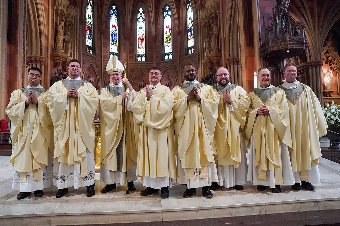 Newly-ordained priests and deacon pose with Bishop Edward B. Scharfenberger, third from left, and Father Father Brian Kelly, Vicar for Vocations, following the combined Ordination of Priests and Deacons on Saturday May 20, 2023, at the Cathedral of Immaculate Conception in Albany, N.Y. From left are Father Joseph Tuan Van Pham, Father Paul McDonald, Bishop Edward B. Scharfenberger, Deacon Eric Ramirez, Father Anthony Chibueze Onu, Father Adam Feisthamel, Father Thomas Fallati and Father Brian Kelly.  Cindy Schultz for The Evangelist
