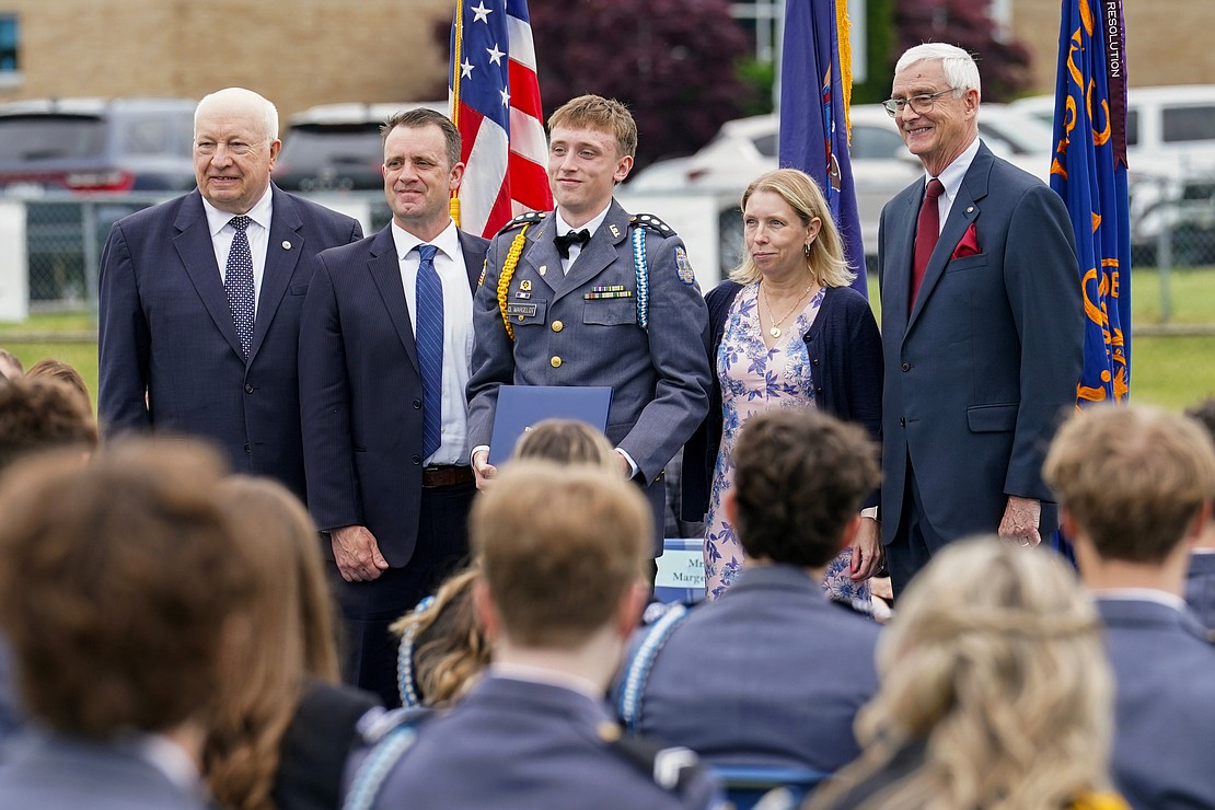 Graduate Michael Margelot, center, poses for a photo with out-going president Joseph Raczkowski, left, his parents Jamie and Jennifer Margelot, and commencement speaker Donald Reutemann during commencement exercises on Saturday May 18, 2024, at La Salle Institute in Troy, N.Y.  Cindy Schultz for The Evangelist