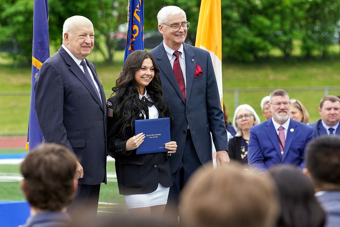 Graduate Hadley Wiesenforth, center, poses for a photo with out-going president Joseph Raczkowski, left, and commencement speaker Donald Reutemann during commencement exercises on Saturday May 18, 2024, at La Salle Institute in Troy, N.Y.  Cindy Schultz for The Evangelist