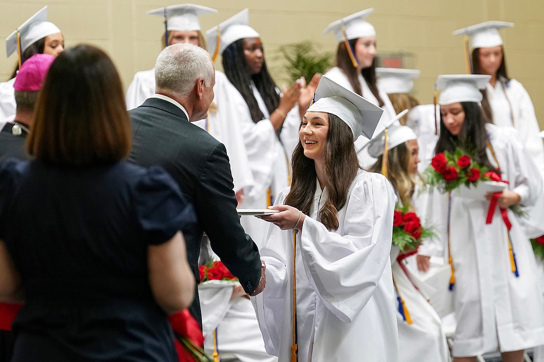 Graduate Emma Lindemann, center, receives her diploma from principal Martin Kilbridge during commencement exercises on Friday May 24, 2024, at the Academy of the Holy Names in Albany, N.Y.  Cindy Schultz for The Evangelist
