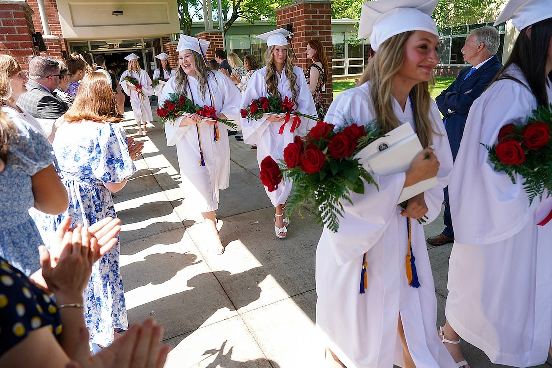 Graduate Meredith Brown, center left, smiles at clapping faculty members as she walks with Mary Masterson and their class at the end of commencement exercises on Friday May 24, 2024, at the Academy of the Holy Names in Albany, N.Y.  Cindy Schultz for The Evangelist