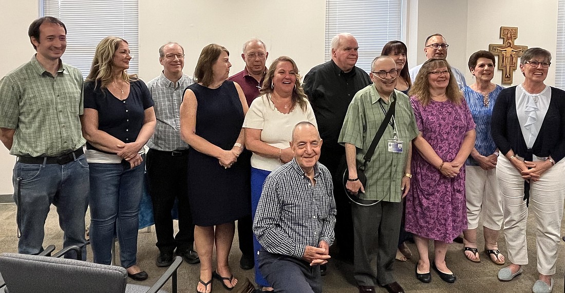 Graduates of the Diocese’s first Pastoral Associate for Leadership Formation Program take a picture with David Amico (ninth from l.), Director of the Office for Discipleship Formation. (Emily Benson photo)