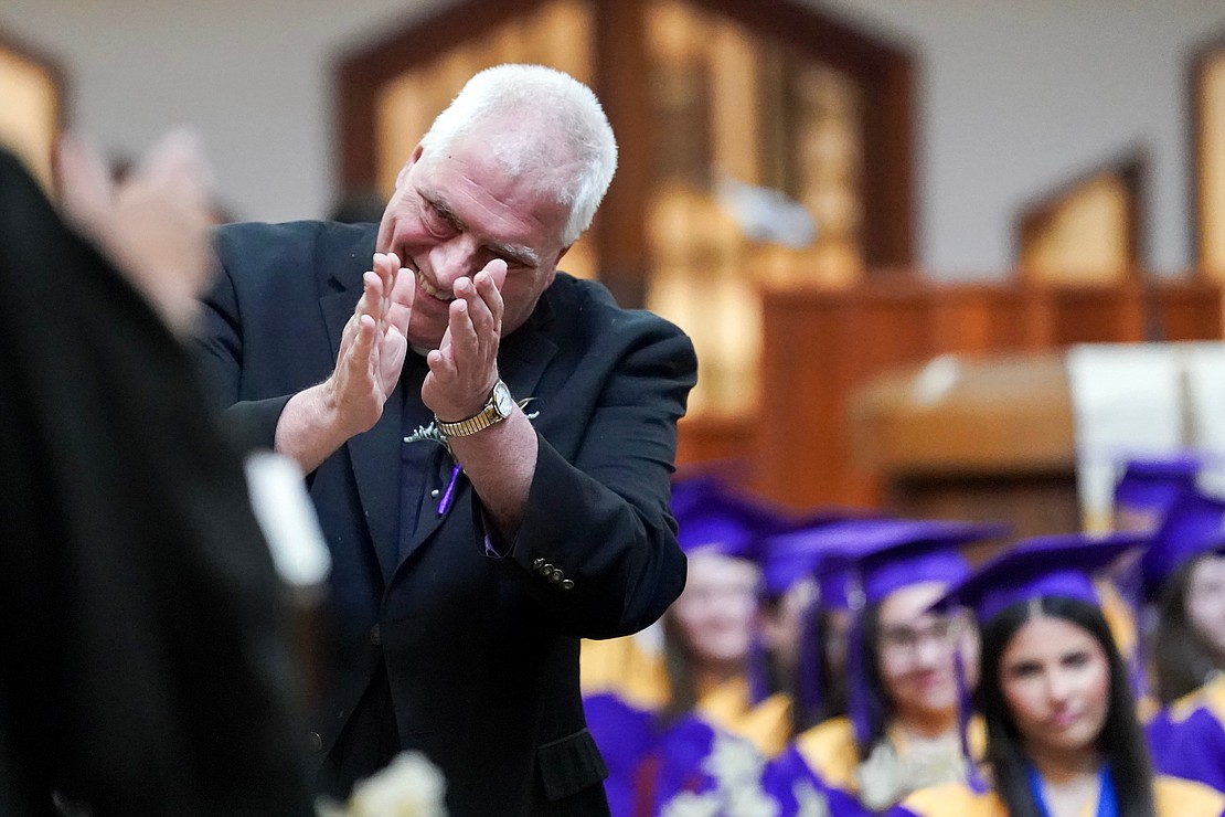 Father Bob Longobucco is introduced to deliver an address to graduates during commencement exercises for Saratoga Central Catholic School on Friday, June 7, at Corpus Christi Church in Round Lake. (Cindy Schultz photo for The Evangelist)