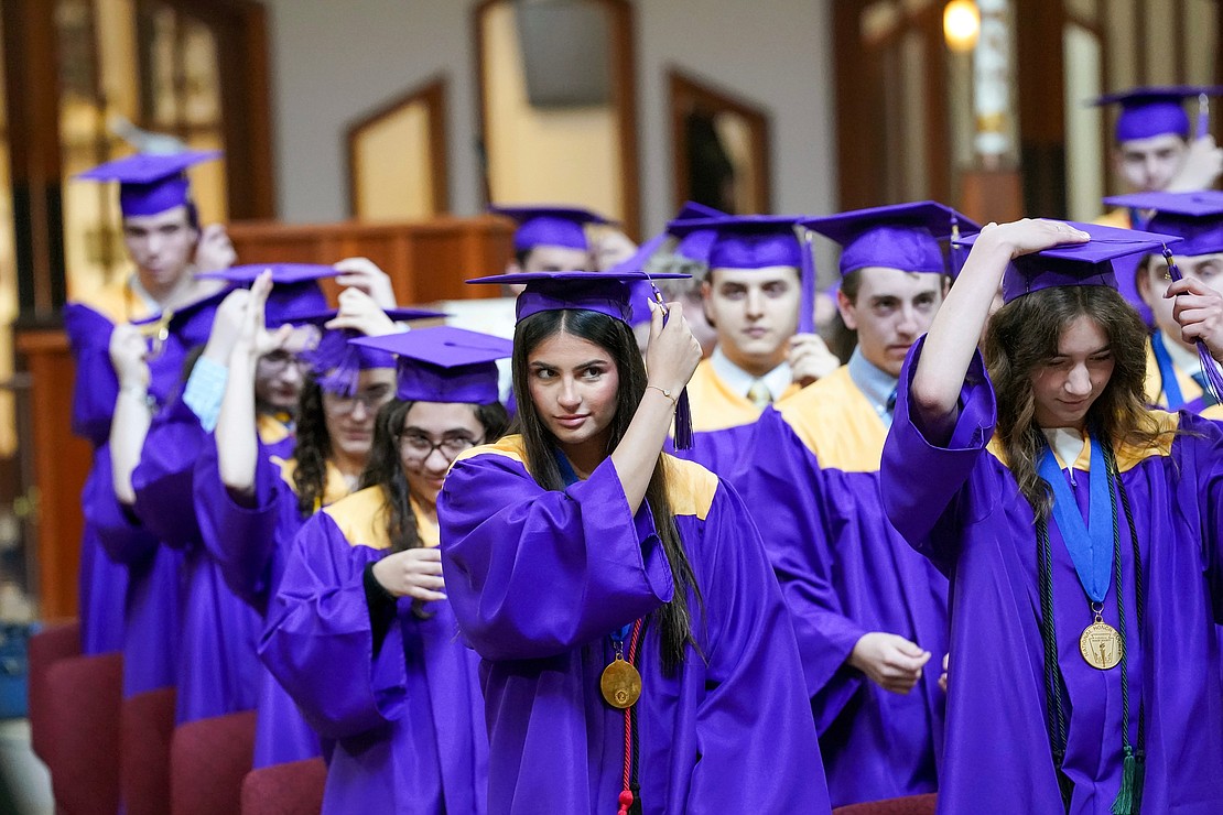 Graduates turn their tassels to show they’ve officially graduated during commencement exercises for Saratoga Central Catholic School on Friday, June 7, at Corpus Christi Church in Round Lake. (Cindy Schultz photo for The Evangelist)