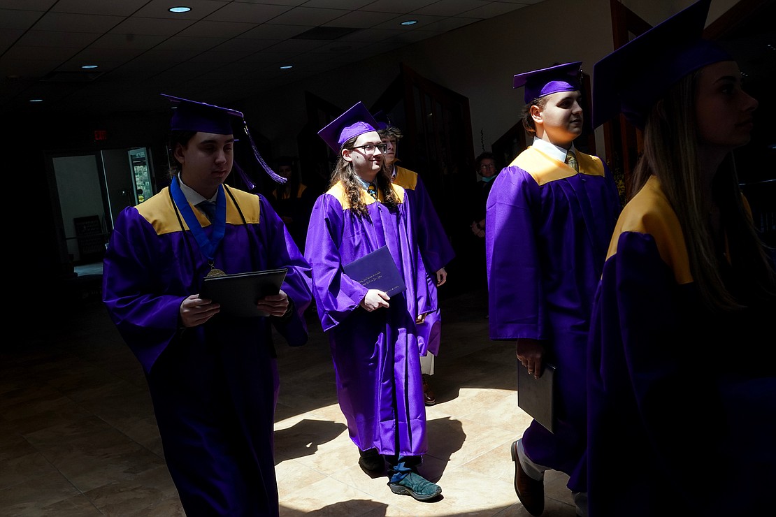 Graduate Angelo Lefebvre, center, joins fellow graduates following commencement exercises for Saratoga Central Catholic School on Friday, June 7, at Corpus Christi Church in Round Lake. (Cindy Schultz photo for The Evangelist)