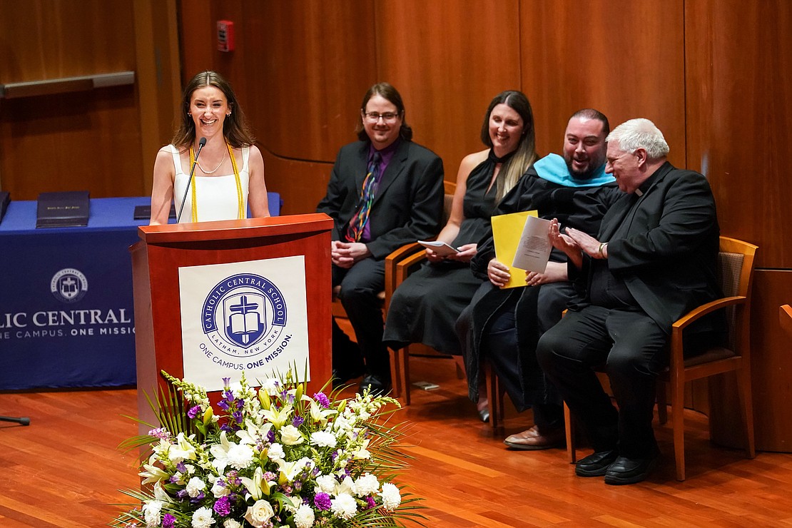 Salutatorian Emily Wheland teases her father about having to miss the Belmont Stakes thoroughbred race, which was takin place on the same day as her graduation, during commencement exercises for Catholic Central School on June 8, at the Massry Center for the Arts in Albany.(Cindy Schultz photo for The Evangelist)