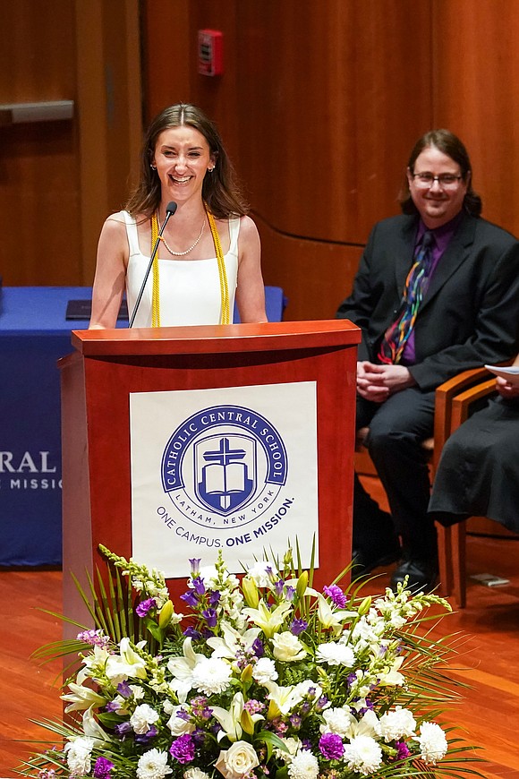 Salutatorian Emily Wheland teases her father about having to miss the Belmont Stakes thoroughbred race, which was takin place on the same day as her graduation, during commencement exercises for Catholic Central School on June 8, at the Massry Center for the Arts in Albany.(Cindy Schultz photo for The Evangelist)