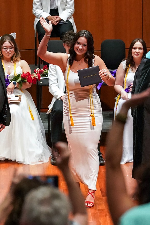 Graduate Tessa Forcucci, center, waves to cheering family members as she receives her diploma during commencement exercises for Catholic Central School on June 8, at the Massry Center for the Arts in Albany.(Cindy Schultz photo for The Evangelist)