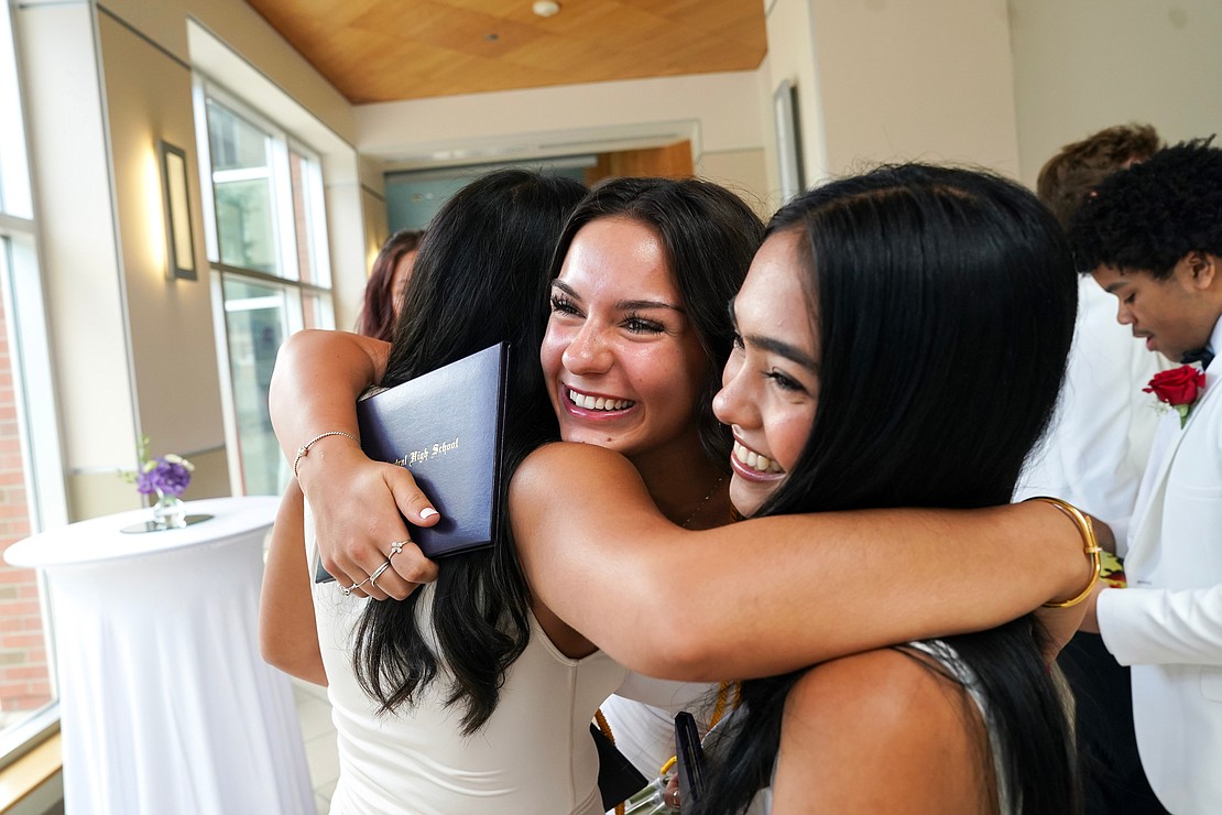 Tessa Forcucci, center, and Camilia Mirocco, right, celebrate with fellow graduates following commencement exercises for Catholic Central School on June 8,  at the Massry Center for the Arts in Albany.(Cindy Schultz photo for The Evangelist)