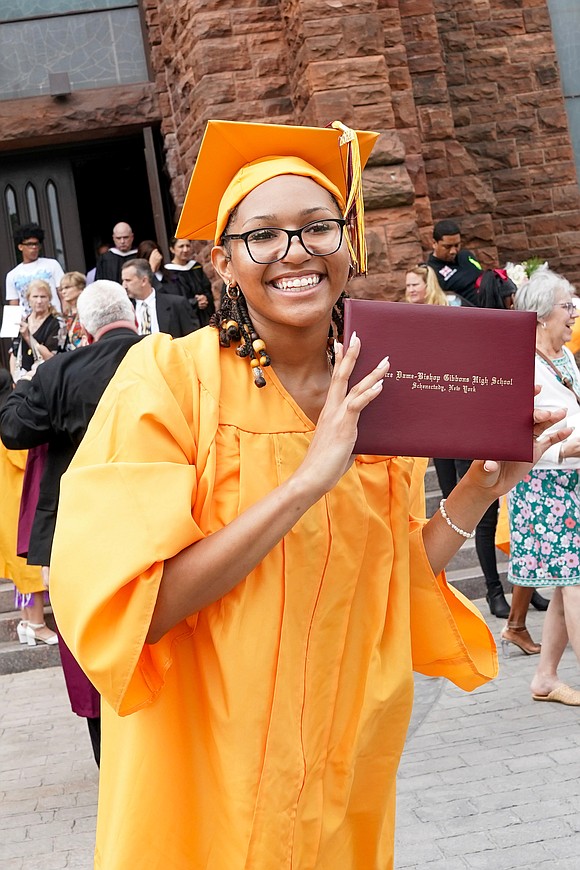 Graduate Mia’Rose Wylie shows off her diploma following Notre Dame – Bishop Gibbons commencement exercises on Saturday, June 8, 2024, at St. John the Evangelist Church in Schenectady, N.Y.  Cindy Schultz for The Evangelist