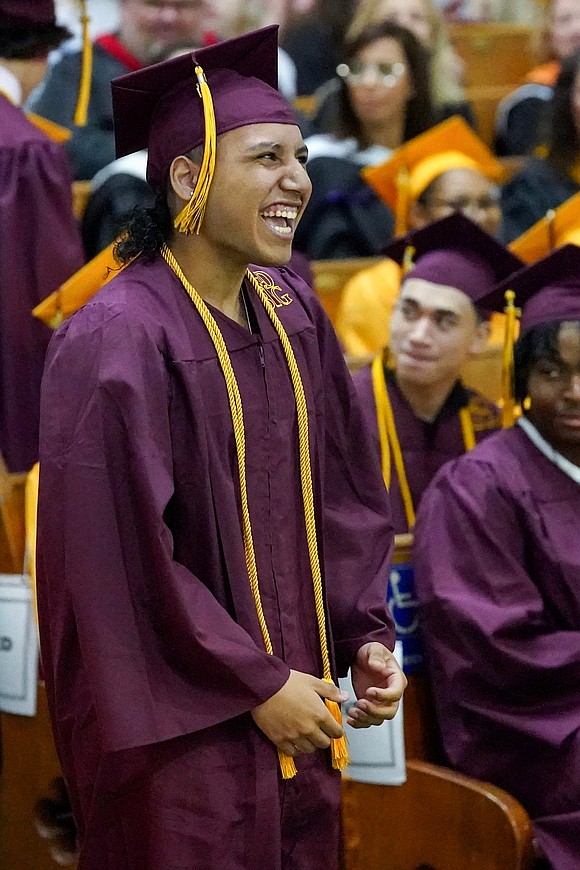 Graduate Giovanni Manmohan, center, celebrates the moment during Notre Dame – Bishop Gibbons commencement exercises on Saturday, June 8, 2024, at St. John the Evangelist Church in Schenectady, N.Y.  Cindy Schultz for The Evangelist