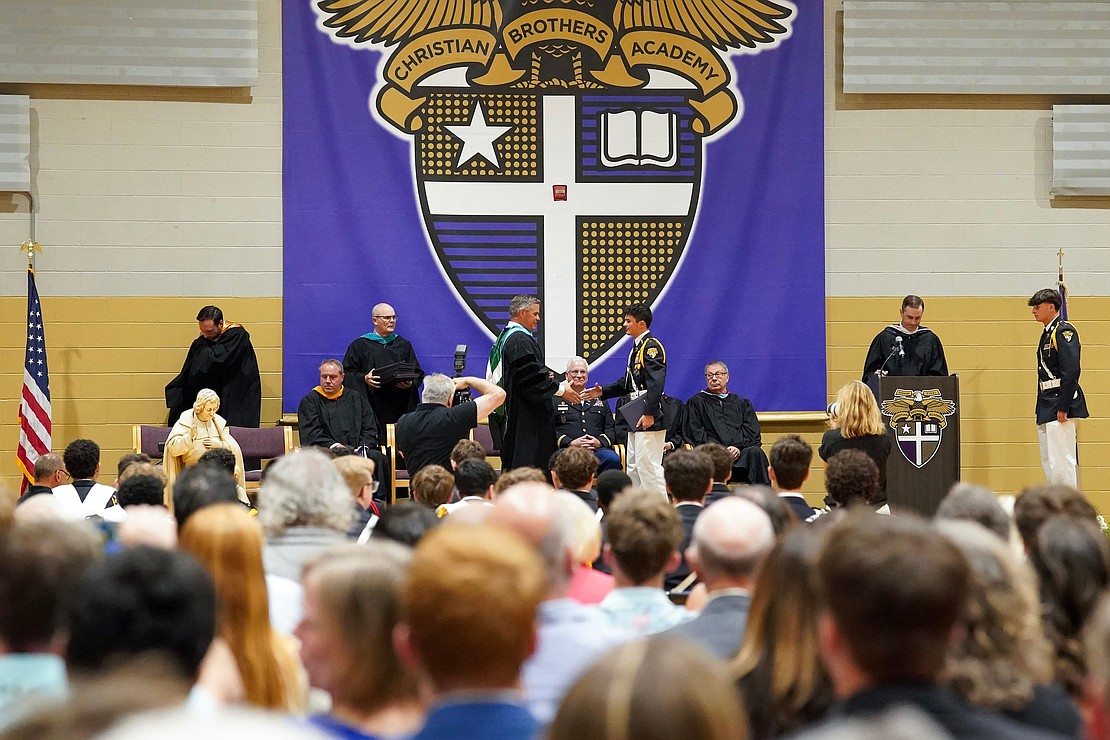 Principal Charles Abba, center left, presents diplomas to graduates during commencement exercises on Friday, May 31, 2024, at Christian Brothers Academy in Colonie, N.Y.  Cindy Schultz for The Evangelist