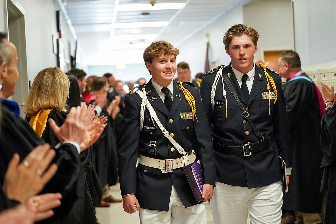 Graduates Thaddeus Mangione and Benjamin Keens walk past a line of clapping faculty members at the conclusion of commencement exercises on Friday, May 31, 2024, at Christian Brothers Academy in Colonie, N.Y.  Cindy Schultz for The Evangelist