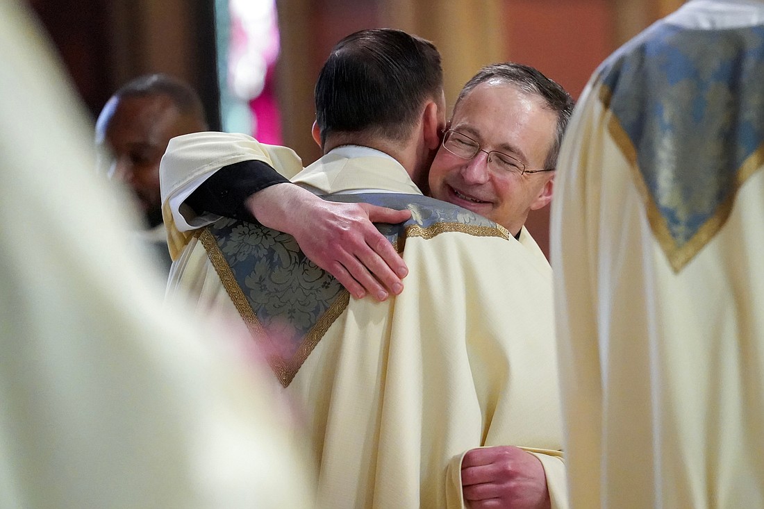 Newly ordained priest Thomas Fallati, center, is welcomed into the priesthood during the Ordination of Priests on Saturday, May 18, 2024, at The Cathedral of the Immaculate Conception in Albany, N.Y.  Cindy Schultz for The Evangelist