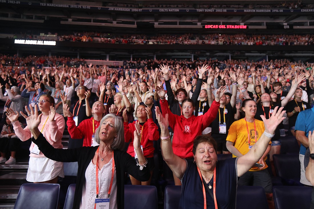 Pilgrims sing along with Catholic musician Matt Maher during the July 20, 2024,  revival night of the National Eucharistic Congress at Lucas Oil Stadium in Indianapolis. (OSV News photo/Bob Roller)