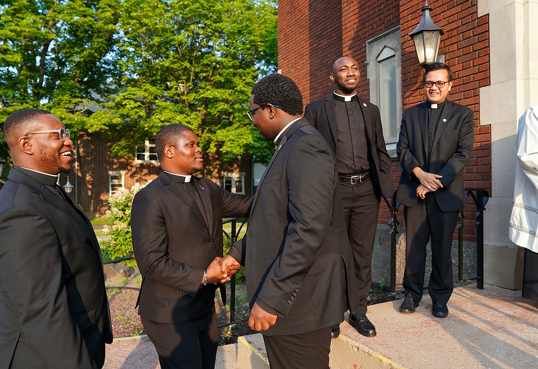 Candidate Samuel Zuze receives congratulations from seminarian Gilbert Kimaro following the Rite of Candidacy and the Rite of Sending on Aug. 1 at Holy Trinity Church in Cohoes. Joining them are candidates Franklin Anyanechi (l.) and Zephyrinus Ogbenna (second from r.)and seminarian Vantuan Cao. (Cindy Schultz photo for The Evangelist)