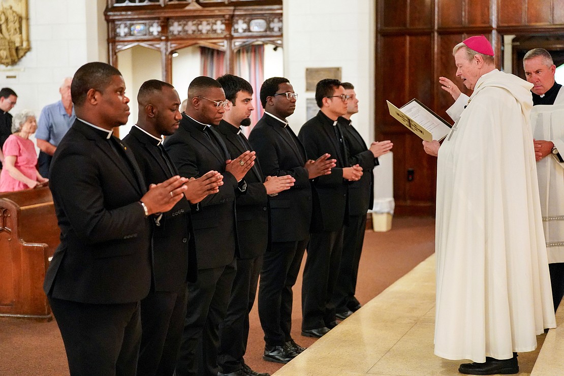 Bishop Edward B. Scharfenberger blesses candidates and seminarians during the Rite of Candidacy and the Rite of Sending on Aug. 1 at Holy Trinity Church in Cohoes. From left are candidates Samuel Zuze, Zephyrinus Ogbenna and Franklin Anyanechi, and seminarians Alessio Fasullo, Gilbert Kimaro, Vantuan Cao and Alexander Turpin. (Cindy Schultz photo for The Evangelist)