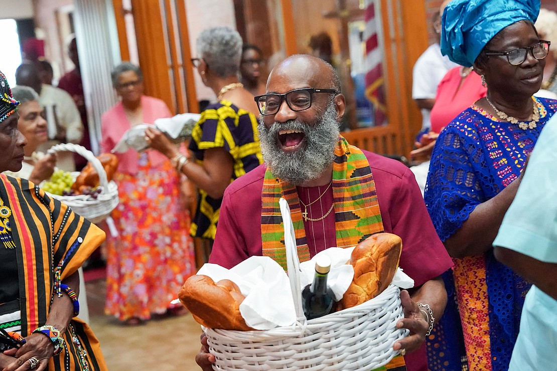 Mario Arthur carries a basket of gifts during mass to celebrate the 40th anniversary of the Black Catholic Apostolate on Sunday, Aug.11, 2024, at St. Joan of Arc in Menands, N.Y.  Cindy Schultz for The Evangelist