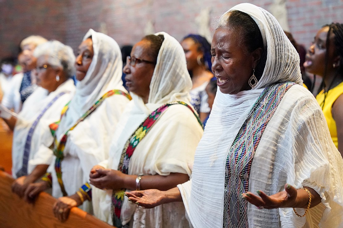 Tejitu Molla, right, a founding member of the church, prays during mass to celebrate the 40th anniversary of the Black Catholic Apostolate on Sunday, Aug.11, 2024, at St. Joan of Arc in Menands, N.Y.  Cindy Schultz for The Evangelist