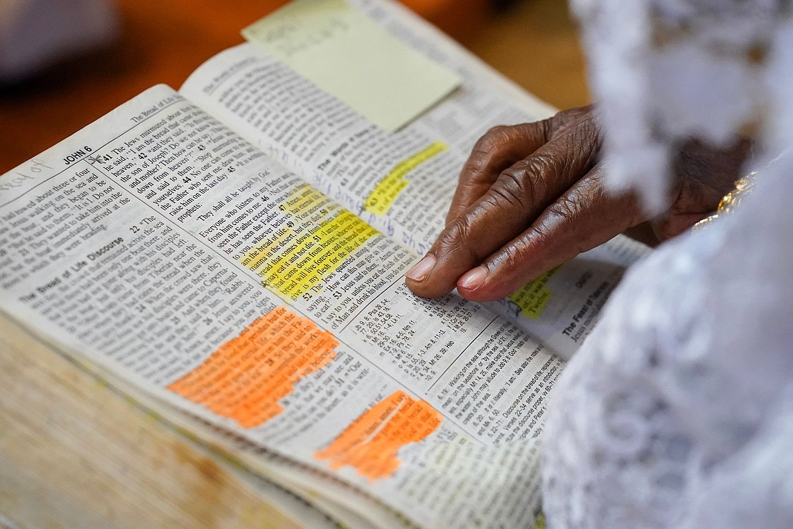 Elizabeth Amissah follows along in her Bible during mass to celebrate the 40th anniversary of the Black Catholic Apostolate on Sunday, Aug.11, 2024, at St. Joan of Arc in Menands, N.Y.  Cindy Schultz for The Evangelist