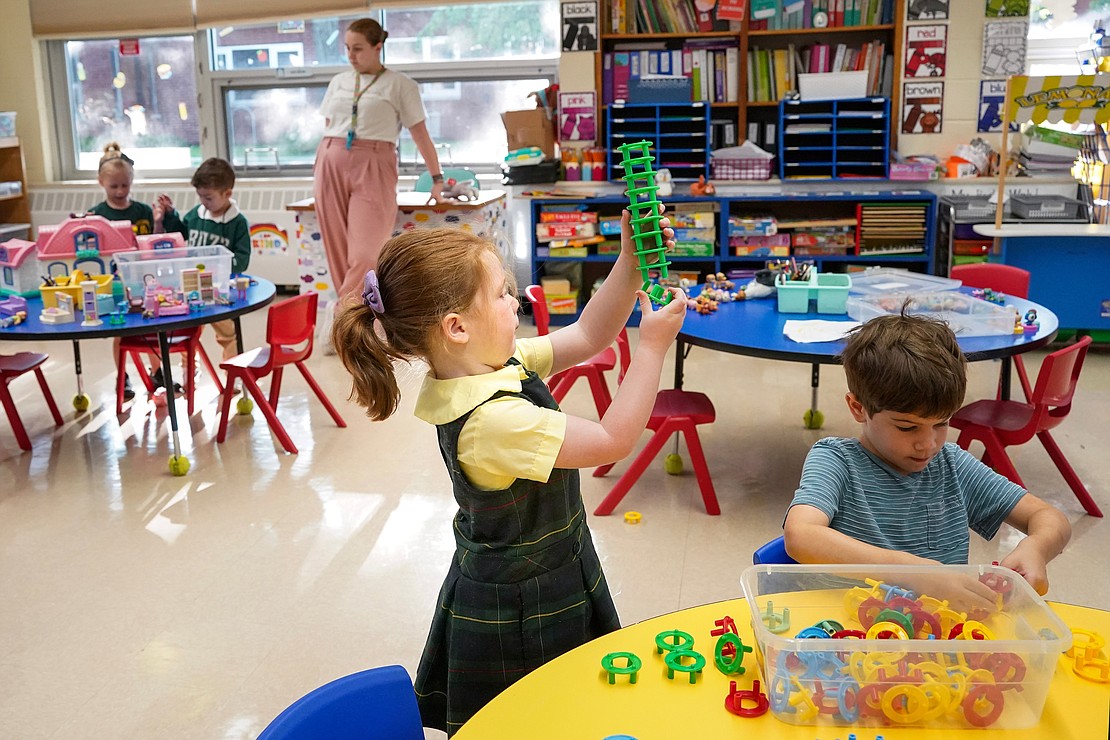 Lyra Westfall-Conheady, center, builds a tower in the Universal Pre-K classroom on Sept. 11 at Mater Christi School in Albany. These Pre-K students are part of a new partnership with the Guilderland School District. (Cindy Schultz photo for The Evangelist)