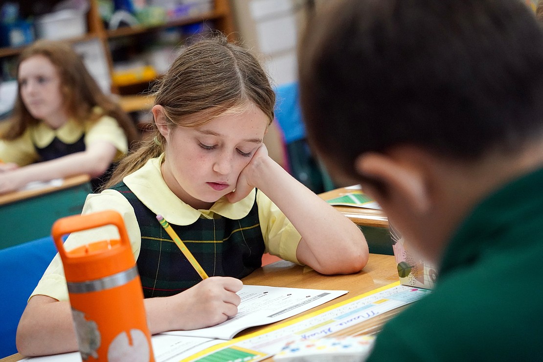 Mavid Gray considers her words in fourth-grade Creative Arts class on Sept. 11 at Mater Christi School in Albany. (Cindy Schultz photo for The Evangelist)