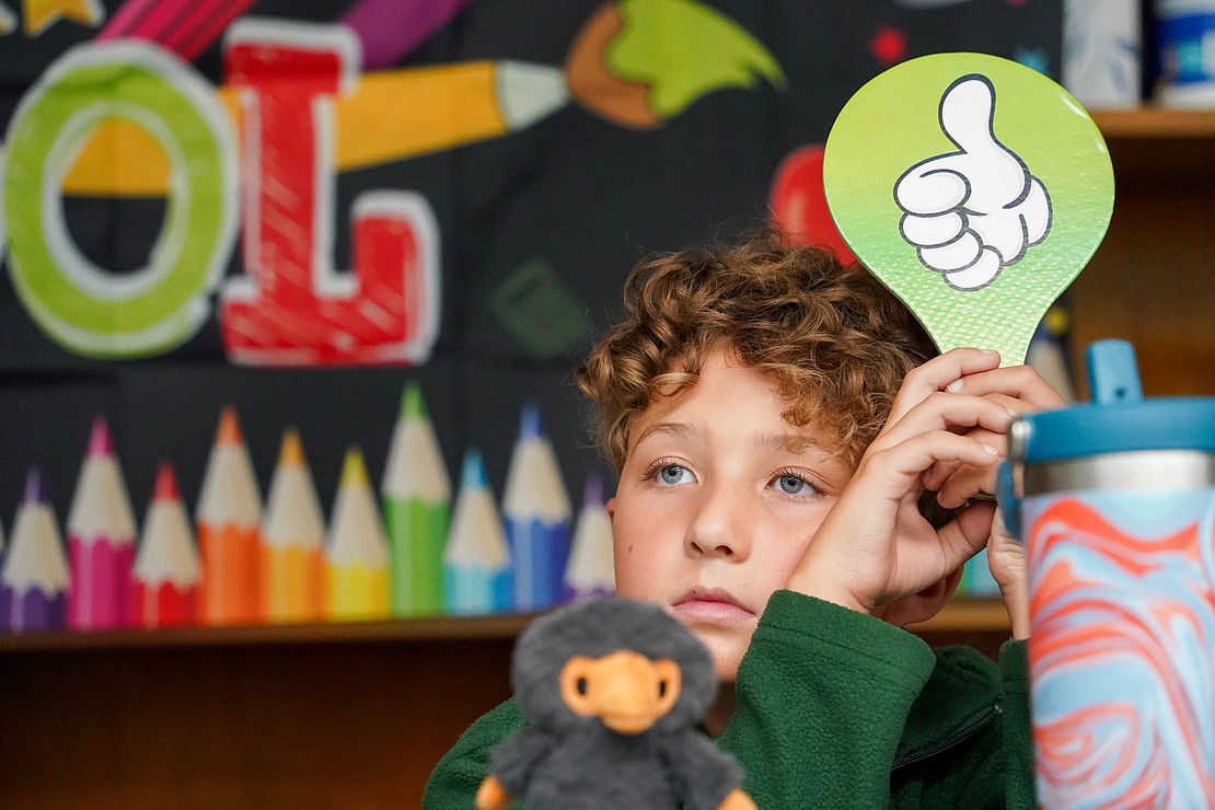 Zachary Person holds a Thumbs-up sign to indicate he’s finished the in-class assignment in his third-grade class on Sept. 11 at Mater Christi School in Albany. (Cindy Schultz photo for The Evangelist)