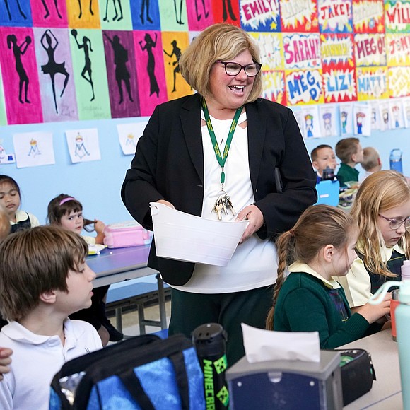 Principal Katie Stalker, center, talks with students in the cafeteria on Sept. 11 at Mater Christi School in Albany. (Cindy Schultz photo for The Evangelist)