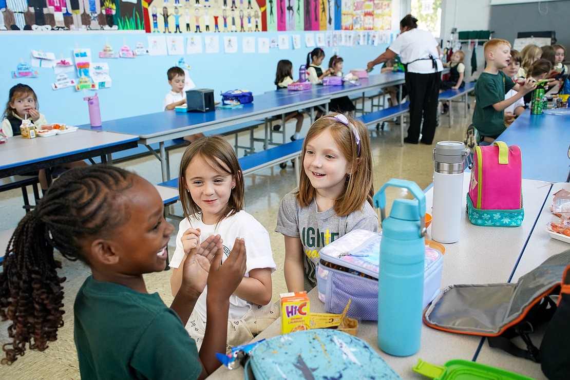 Second-grade classmates Aria Hankins(from l.), Aoife Neville and Amara Corcione enjoy lunch together in the cafeteria on Sept. 11 at Mater Christi School in Albany. (Cindy Schultz photo for The Evangelist)