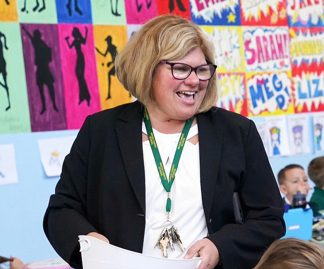 Principal Katie Stalker, shown talking with students in the cafeteria on Sept. 11 at Mater Christi School in Albany, said the parents and teachers, school board and the faithful in the parish are all instrumental to the school’s success. (Cindy Schultz photo for The Evangelist)