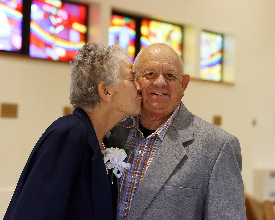 Marianne Mitchell gives her husband, Julius, a kiss before the 52nd Diocesan Marriage Jubilee Celebration on Sept. 29 at Christ Our Light Church. The Mitchells have been married for 57 years. (Tom Killips photo)