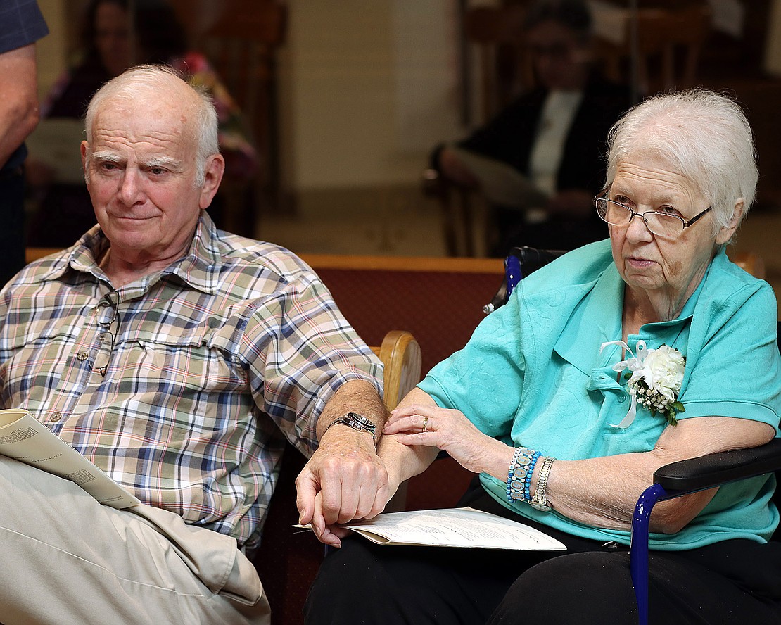 Les and Barbara Samiof hold hands during the 52nd Annual Diocesan Marriage Jubilee Celebration at Christ Our Light Church on Sept. 29. They have been married 50 years and this is their home church and their regular spot. (Tom Killips photo)