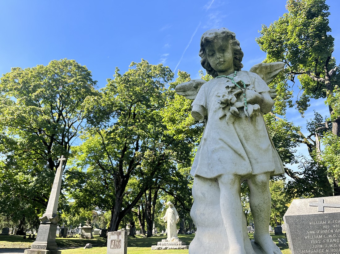 An angel statue marks the grave of 8-year-old Loretta inside St. Agnes Cemetery in Menands. In her hand, she holds rose buds, which are symbolic of a flower that would never fully bloom. (Emily Benson photo)