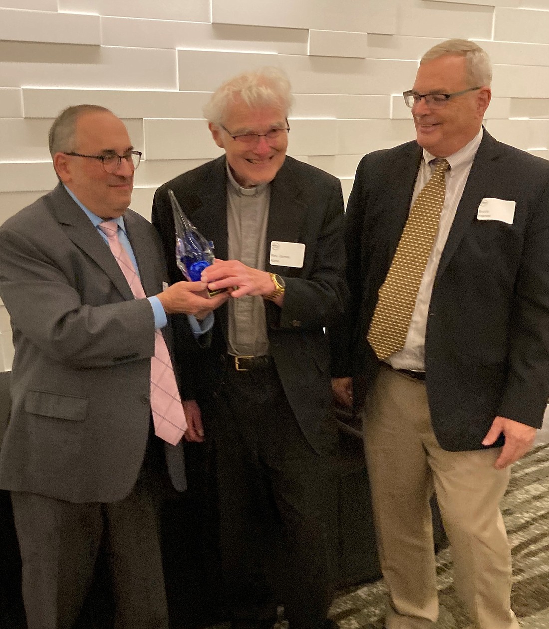 Father James Kane is shown with David Amico (l.), director for the diocesan Office for Discipleship Formation, and Bruce France, executive director of Capital Area Council of Churches, after receiving the Evelyn Stone Lifetime Achievement Award. (Photo provided)