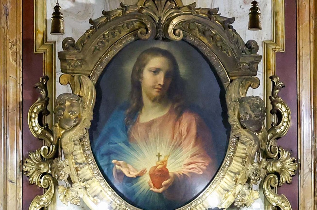 A painting by Pompeo Batoni of the Sacred Heart of Jesus from 1767 is displayed in an ornate frame inside the Jesuit Church of the Gesù in Rome, Oct. 22, 2024. (CNS photo/Lola Gomez)