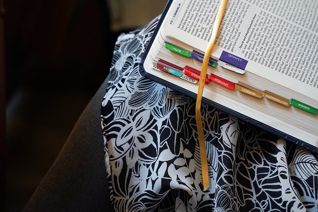 Susan Salisbury of St. Mary of the Assumption in Waterford opens her Bible during the Unleashing Love Diocesan Women’s Retreat Oct. 19 at St. Edward the Confessor in Clifton Park. (Cindy Schultz photo for The Evangelist)