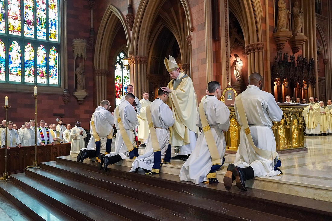 Bishop Edward B. Scharfenberger lays his hands upon the candidates during their Ordination to the Priesthood on May 18 at The Cathedral of the Immaculate Conception in Albany. (Cindy Schultz photo for The Evangelist)