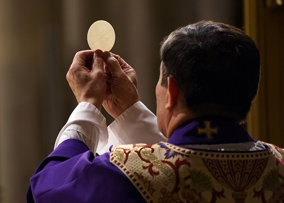 A priest elevates the host during a Mass at St. Patrick's Cathedral in this file photo. (OSV News photo/Gregory A. Shemitz)