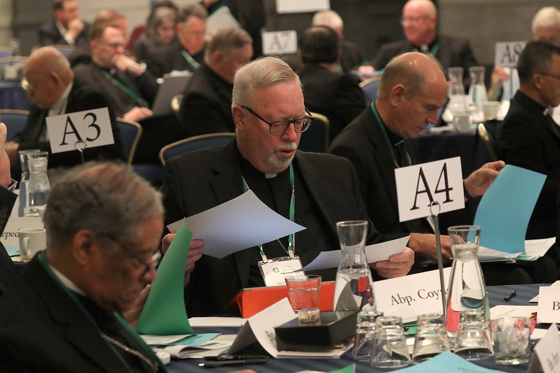 Archbishop Christopher J. Coyne of Hartford, Conn., looks over paperwork during a Nov. 13, 2024, session of the fall general assembly of the U.S. Conference of Catholic Bishops in Baltimore. (OSV News photo/Bob Roller)