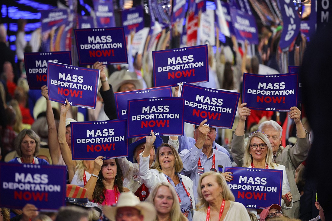 Delegates hold "Mass deportation now!" signs on Day 3 of the Republican National Convention at the Fiserv Forum in Milwaukee July 17, 2024. (OSV News photo/Brian Snyder, Reuters)