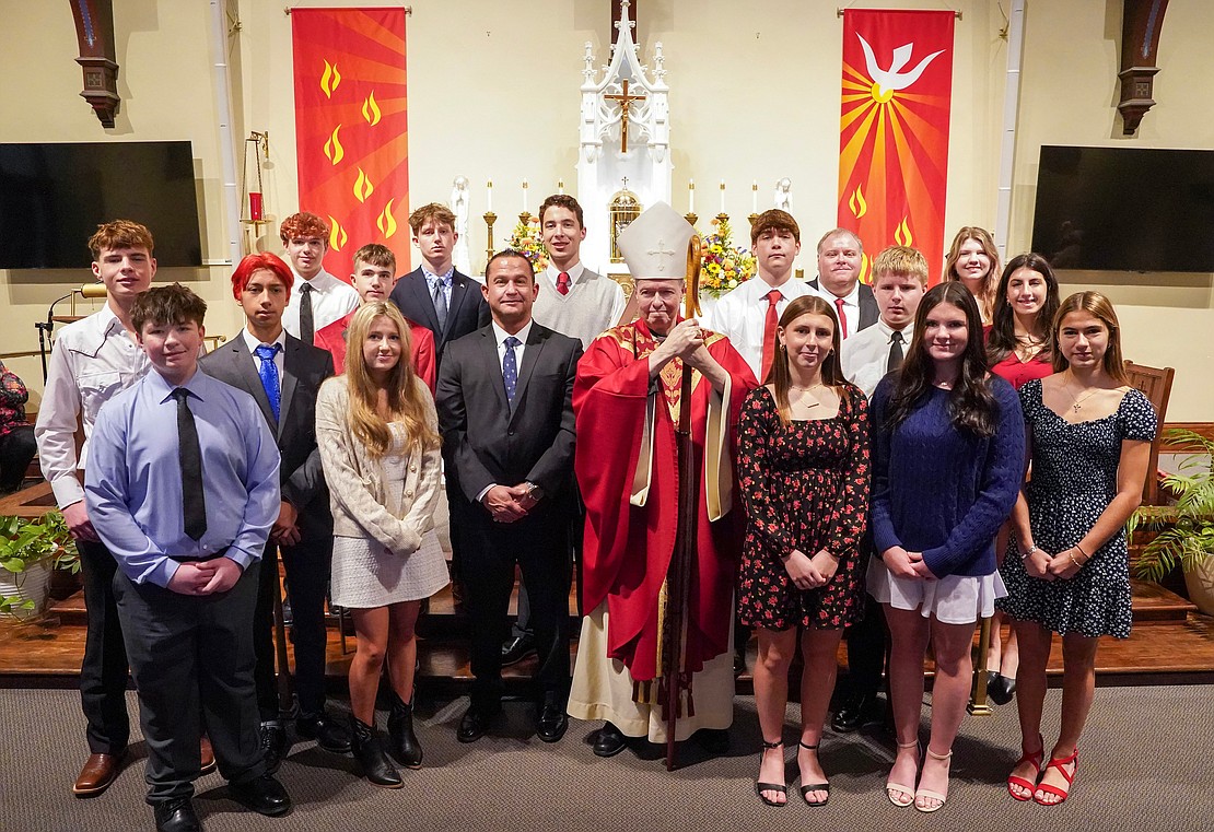 Bishop Edward B. Scharfenberger is shown with the newly confirmed students and parishioners on Nov. 23 at the Church of the Holy Spirit in East Greenbush. (Cindy Schultz photo for The Evangelist)