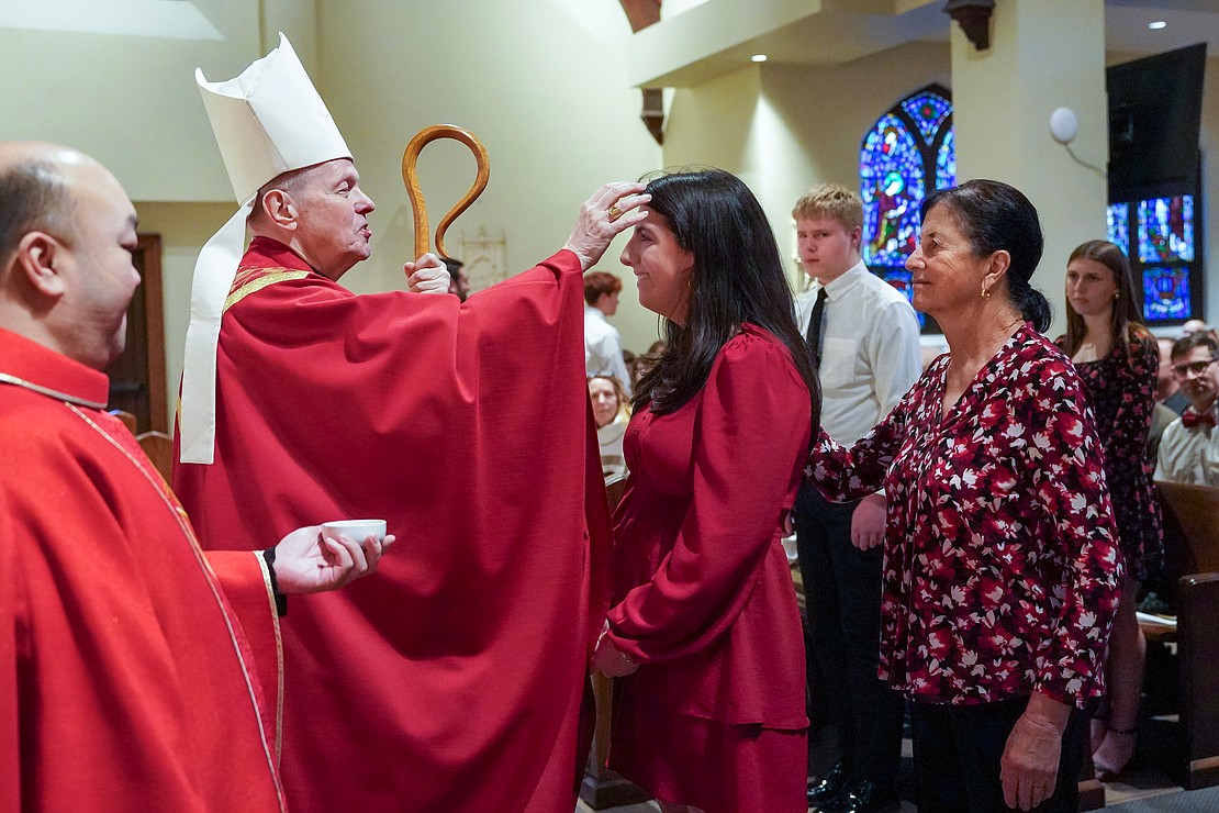 Bishop Edward B. Scharfenberger anoints Mia Jensen of St. John the Evangelist in Schenectady on Nov. 23 at the Church of the Holy Spirit in East Greenbush. (Cindy Schultz photo for The Evangelist)