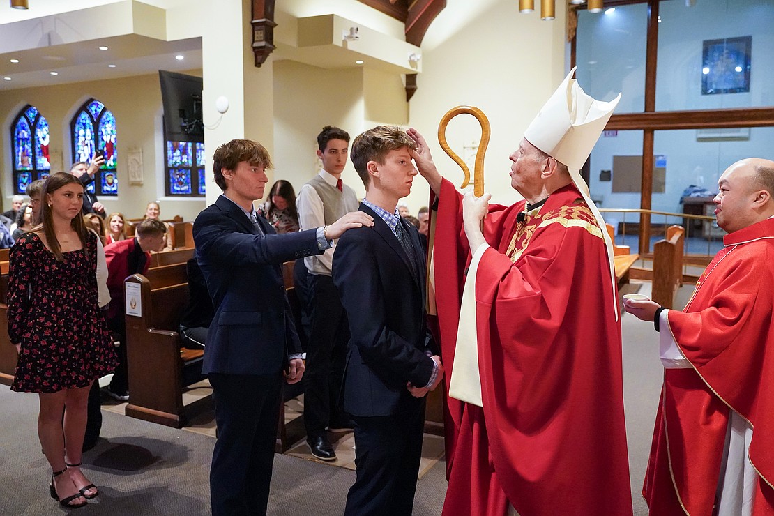 Bishop Edward B. Scharfenberger anoints Samuel Branon of Holy Spirit during confirmation on Nov. 23 at the Church of the Holy Spirit in East Greenbush. (Cindy Schultz photo for The Evangelist)