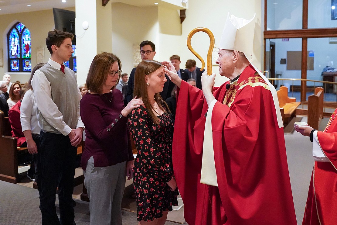 Bishop Edward B. Scharfenberger anoints Olivia Mueller of Sacred Heart during confirmation on Nov. 23 at the Church of the Holy Spirit in East Greenbush. (Cindy Schultz photo for The Evangelist)