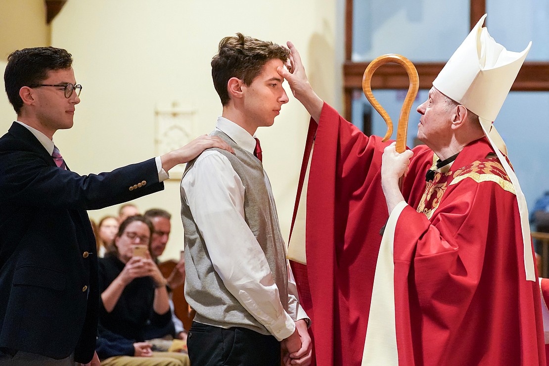 Bishop Edward B. Scharfenberger anoints James Thoma of Holy Spirit during confirmation on Nov. 23 at the Church of the Holy Spirit in East Greenbush. (Cindy Schultz photo for The Evangelist)