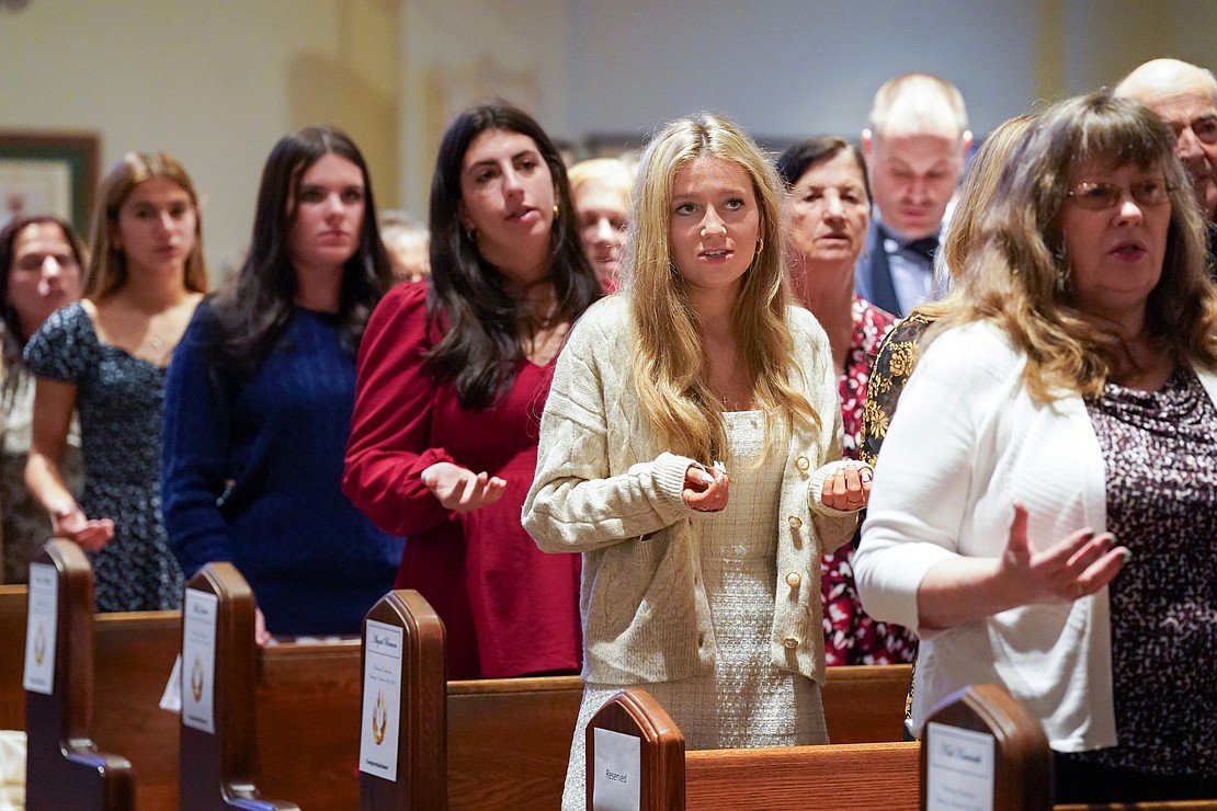 Abigail Branon, (c.) of Holy Spirit, joins her fellow newly confirmed and the congregation in saying the Lord’s Prayer on Nov. 23 at the Church of the Holy Spirit in East Greenbush. (Cindy Schultz photo for The Evangelist)